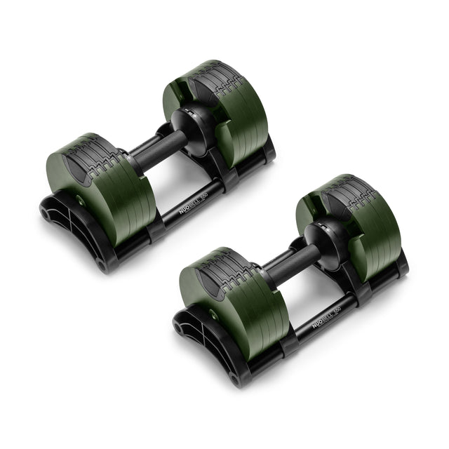 The NÜOBELL Adjustable Dumbbells by Nuobell feature a sleek, modern design with green and black machined steel weight plates. Resting on stands, their compact, patent-pending system makes them perfect for versatile home workouts.