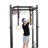 male athlete attaching the Wooden Gymnastic Rings with Straps in a power rack