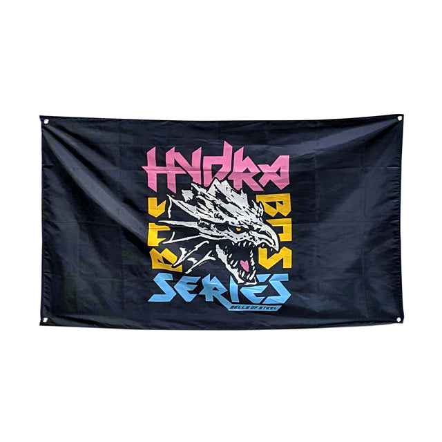 A black flag from Bells of Steel, showcasing a stylized dragon with an open mouth at the center, perfect for gym decor. The words "Hydra Bass Series" are prominently displayed in vibrant colors above and below, making it an ideal addition to your home gym to inspire and energize your workout space.