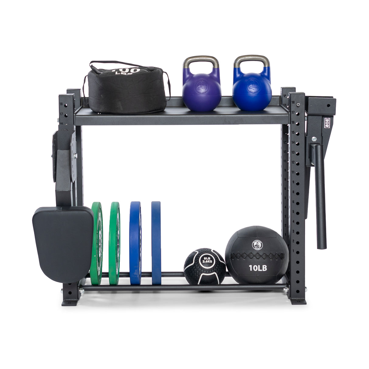 The Hydra Storage Builder by Bells of Steel is a modular gym rack that holds a sandbag, two kettlebells, weight plates, a medicine ball, and a pad. This compact system keeps your home gym organized and showcases exercise tools neatly.