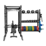 The Hydra Storage Builder by Bells of Steel is a modular gym setup featuring a power rack, bench, and neatly organized dumbbells, kettlebells, and colorful weight plates on racks—perfect for efficient storage and comprehensive strength training in your home gym.