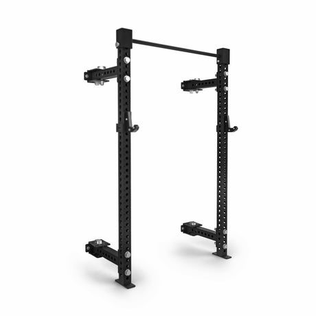 The Bells of Steel Manticore Folding Half Rack (3" x 3", 1" holes) is a black metal modular squat rack with uprights, adjustable hooks, and a pull-up bar—ideal for weightlifting and strength training at home.