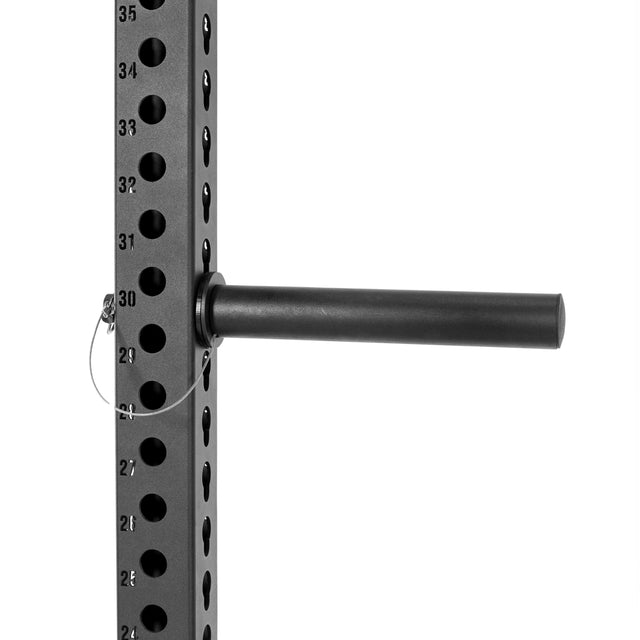 A Bells of Steel Utility Horn Rack Attachment is shown secured by a pin in a black metal weight rack with vertically numbered holes, designed to hold Olympic weight plates.