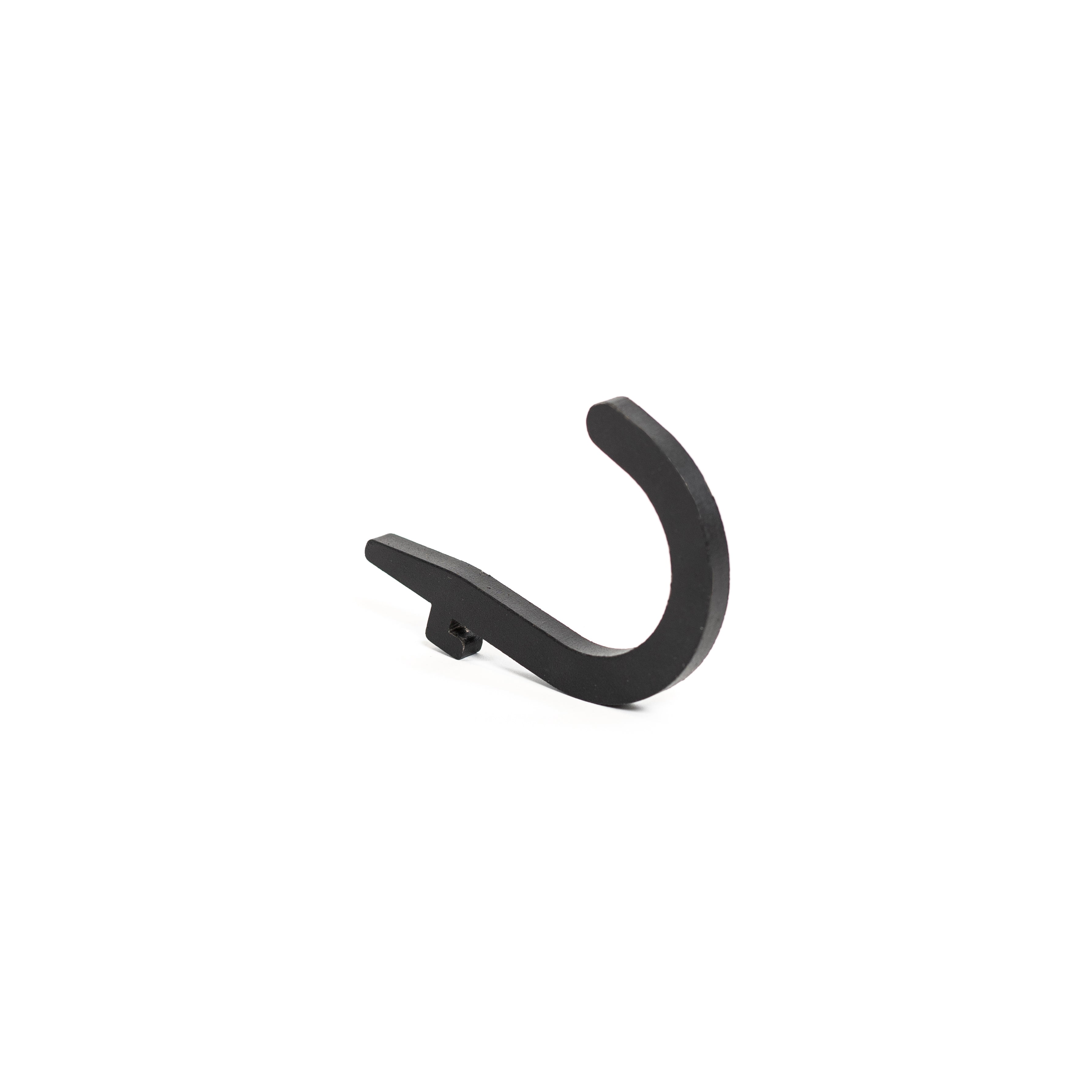 A Bells of Steel Canada Utility Hook, featuring a sleek black curve and crafted from metal, stands against a plain white background. Its straightforward design and angled position make it an ideal choice for gym storage, ensuring your space remains tidy and efficient.