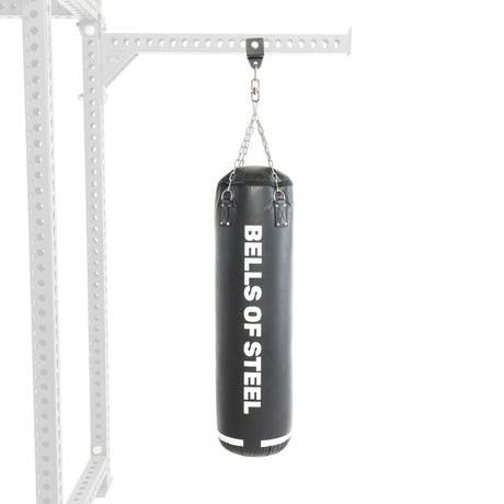 The durable black punching bag from the Heavy Bag Set hangs from a sturdy metal frame, ideal for combat sports training. It features "Bells of Steel" in bold white text on a plain background.