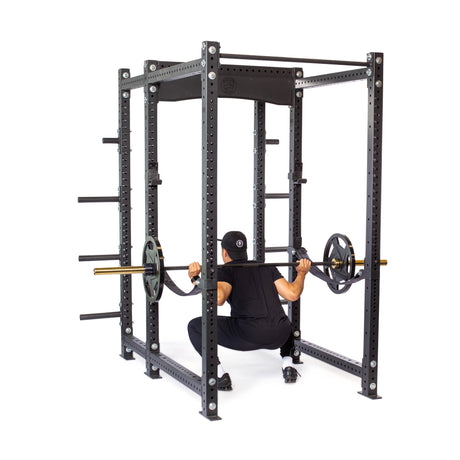 Product picture of Hydra Six Post Power Rack PREBUILT with a male model performing squats