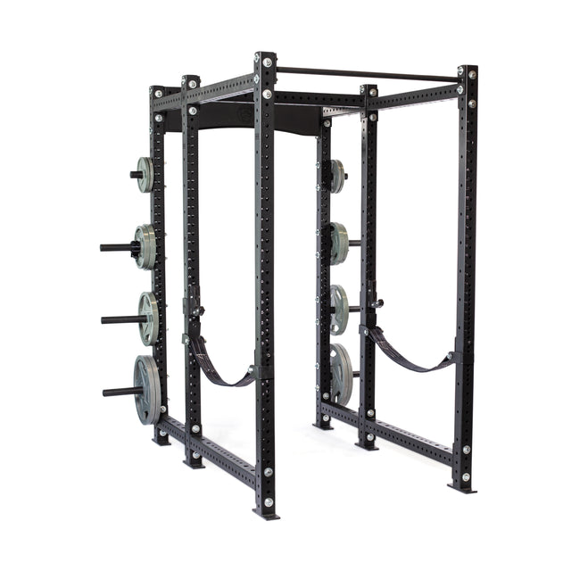 A black Bells of Steel Hydra Six Post Power Rack Builder (3" x 3", ⅝" holes) offers a 1,000-pound capacity with multiple weight plates and safety straps. Its numerous holes allow for adjustable positioning, ideal for various strength training exercises.