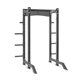 Against a white background, the Hydra Collegiate Power Rack Builder by Bells of Steel features a sleek black design with modular components, including ⅝" holes for adjustable bar placement and weight storage pegs on the sides. Engineered for strength training exercises, its sturdy construction is compatible with accessories such as the Hydra Lat Pulldown.