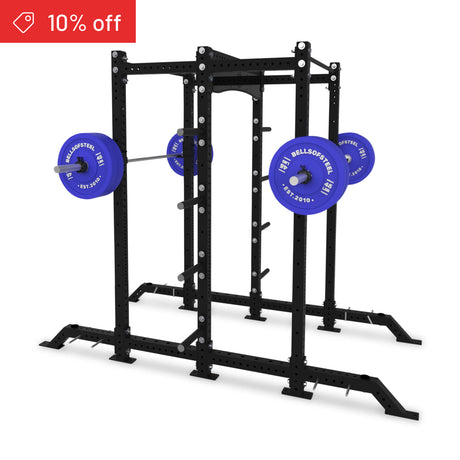 The Bells of Steel Hydra 2-Sided Rack stands on a white background, equipped with a loaded barbell featuring blue plates. A black modular power rack, ideal for home gyms, with a red "10% off" banner in the top-left corner.