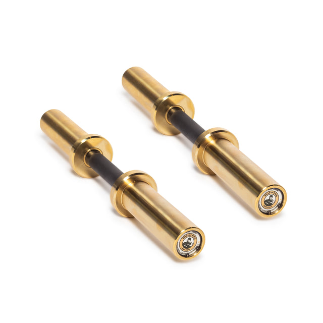 On a white background, two gold-colored cylindrical items with black central rods are placed parallel to each other. They look like Loadable Dumbbell Handles by Bells of Steel, akin to gym equipment components or Olympic bars designed for mechanical or engineering purposes.