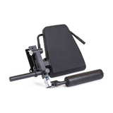 The Bells of Steel Leg Curl / Leg Extension Rack Attachment is a black, adjustable power rack accessory with a padded backrest and cylindrical rollers for comfortable gym leg exercises.
