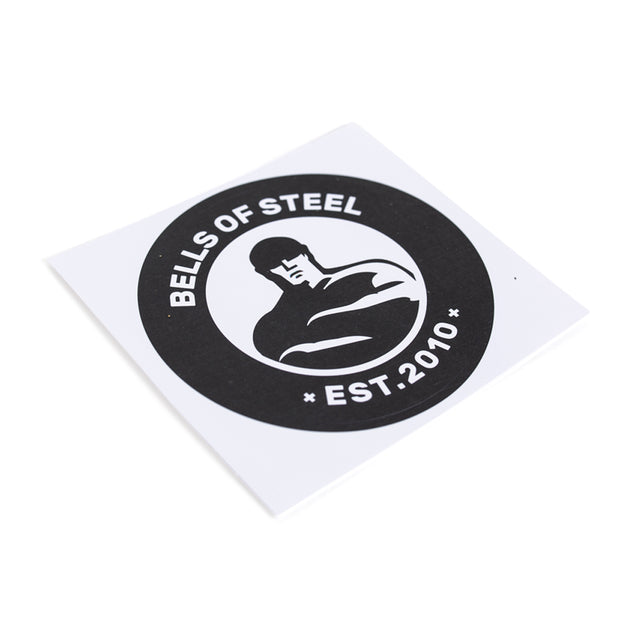 The Bells of Steel stickers feature a durable, die-cut design with a stylized illustration of a muscular figure in black and white. The circular image includes the text "BELLS OF STEEL" at the top and "EST. 2010" at the bottom, set against a square background. All orders come with free shipping.