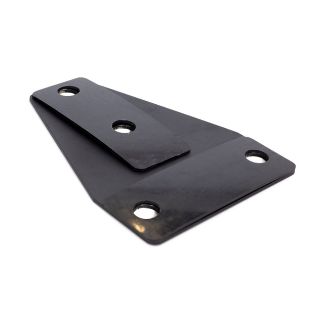 The Manticore Flat Foot Components by Bells of Steel are black metal brackets with three holes, designed to seamlessly integrate with Manticore power racks. Displayed on a white background, these sturdy components enhance durability and performance.