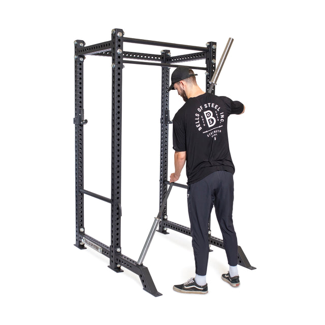 Male model fixing Front Foot Stabilizers to the power rack