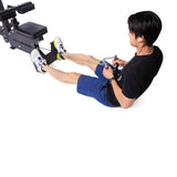 A person wearing a black shirt and blue shorts is engaged in cable rows on a rowing machine. They firmly grip the Bells of Steel Double D Handle Cable Attachment with both hands for optimal muscle engagement, while their feet are firmly placed against the footrests.