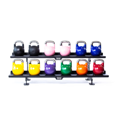 The Bells of Steel Commercial Interchangeable Weight Rack - Components Only neatly displays twelve competition kettlebells in three colorful rows on swappable shelves, organized against a clean white background.