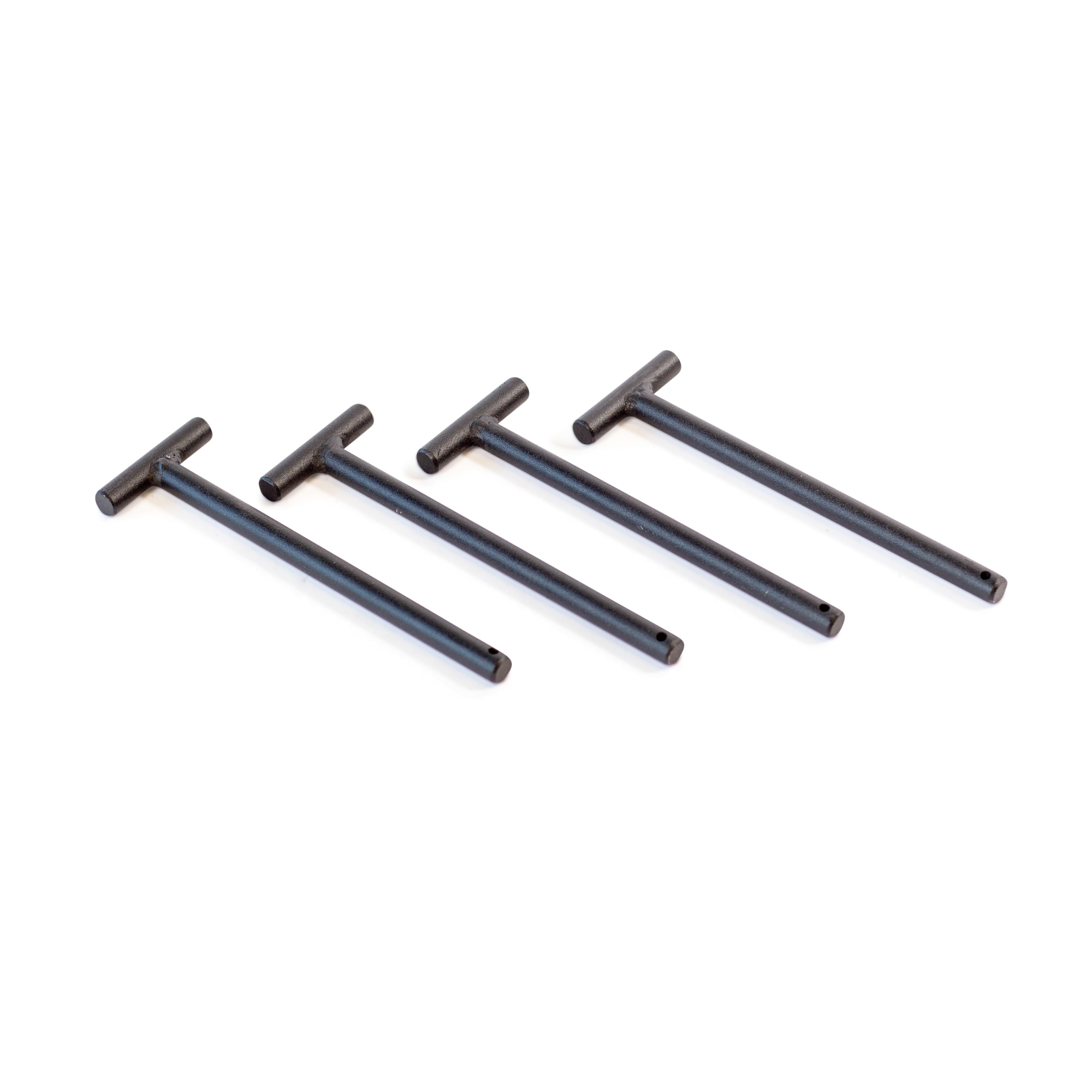 Four identical black Standard Band Pegs by Bells of Steel, resembling the sturdy structure of a power rack, are arranged in a diagonal line on a white background. Each peg features a long handle and a shorter perpendicular piece forming a T-shape.