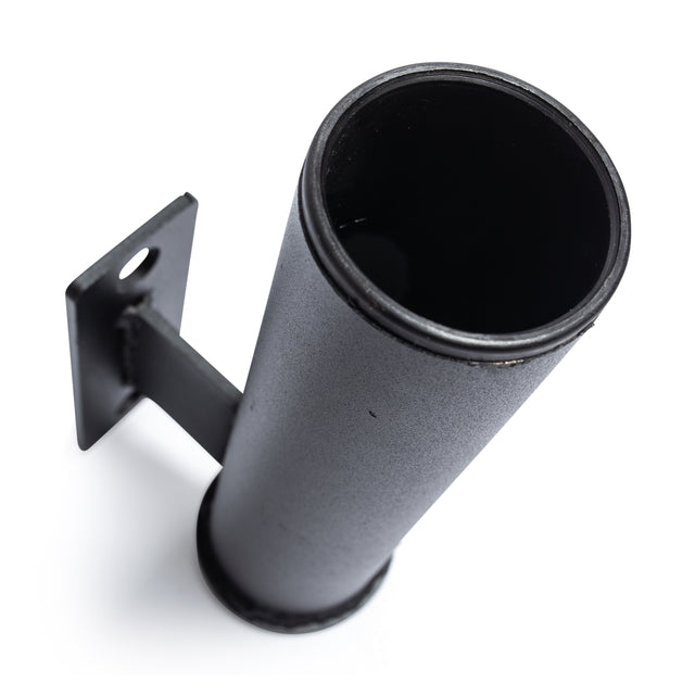 The Vertical Mount Barbell Holder Rack Attachment by Bells of Steel is a robust, dark gray cylindrical metallic holder designed for vertical mounting with a wall bracket. It's ideal for organizing home gym equipment, accommodating items such as barbells, umbrellas, or poles. The background is plain white.