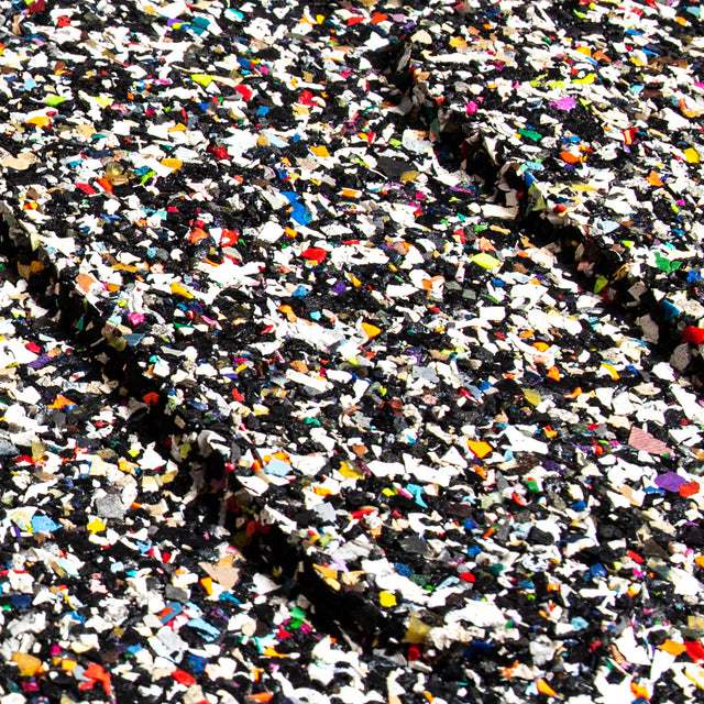 Close-up of the Bells of Steel Rubber Flooring Gym Mat 39" x 39", featuring a textured rubber surface with densely scattered, colorful speckles for a vibrant, mosaic-like look that also provides sound dampening.