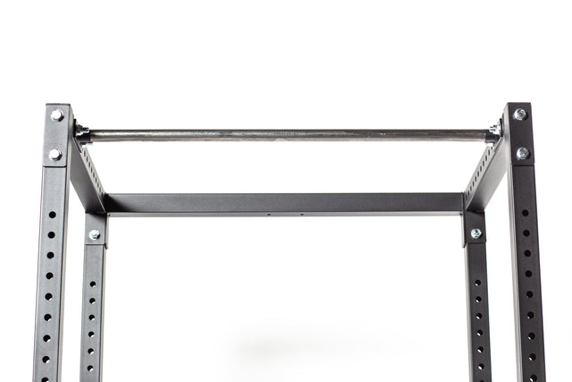 A close-up of the Bells of Steel Residential Power Rack (2.3" x 2.3", ⅝" holes) with a pull-up bar, ideal for any home gym setup. The robust steel beams boast multiple holes for adjustable settings and come with J-cups for versatile lifting options, all set against a plain white background to emphasize the rack's sturdy design.