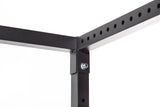 Close-up of a Bells of Steel Residential Power Rack (2.3" x 2.3", ⅝" holes) corner joint, showing a bolt securing two perforated black metal beams—perfect for home gym organization—set against a white background.