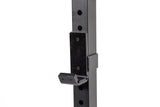Close-up of a black metal j-cup on a Bells of Steel Residential Power Rack (2.3" x 2.3", ⅝" holes), designed for adjustable barbell placement in home gyms or fitness spaces.