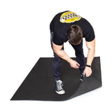 male athlete showing the thickness of the 4' x 6' Rubber Floor Mat