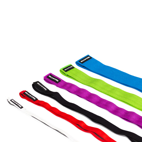 Five 41" Fabric Non-Slip Resistance Bands from Bells of Steel—in white, red, black, green, and blue with “RELIEF SYSTEM” labels—are laid out diagonally on a white background. Ideal for powerlifting resistance bands workouts.