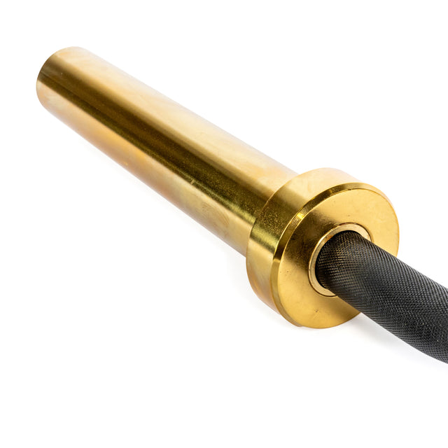 The Bells of Steel Rackable EZ Curl Bar features a gold-colored barbell sleeve with a black textured grip, ideal for targeting biceps and triceps. The sleek design shines against the white background, with a circular flange connecting to the grip.