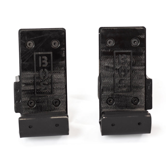 Two black wall brackets with "Bells of Steel" embossed on them, perfect for your power rack setup. Each bracket features four screw holes for secure mounting and a simple, functional design, ideal for holding or supporting items like Standard J-Cups when attached to a wall or surface.