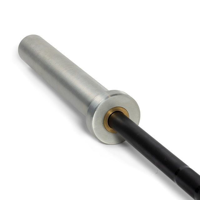 A close-up of the Bells of Steel Juno Bar - Women’s Utility Bar showcases a rust-resistant zinc coating on the metallic silver sleeve and textured black shaft, with a smooth outer sleeve and visible brass bushing at the junction, ideal for those with smaller hands.