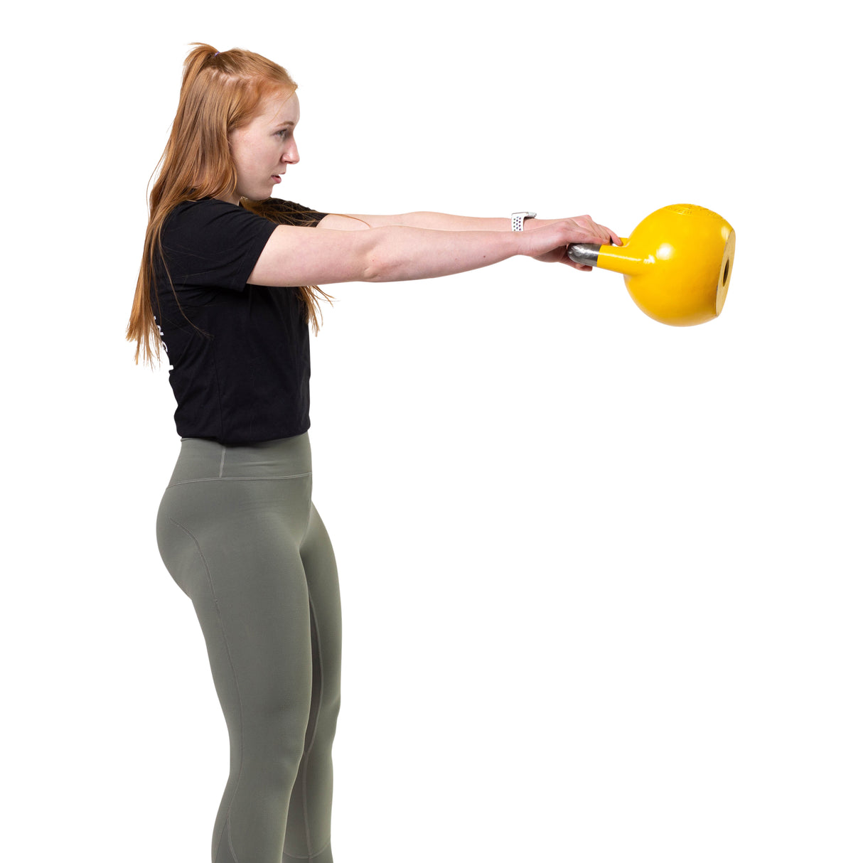 woman working out with yellow kettlebell