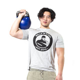 male model holding blue kettlebell