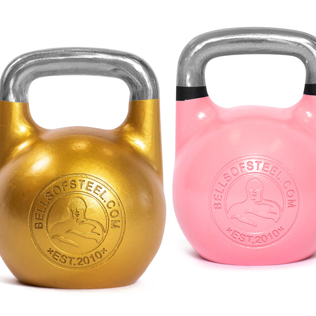 Two Bells of Steel Competition Kettlebells are displayed side by side: one with a gold body and silver handle and the other in pink, both designed ergonomically. They feature embossed text "Bells of Steel" and "EST. 2010," along with a stylized figure at the center, making them ideal for Kettlebell Sport enthusiasts.