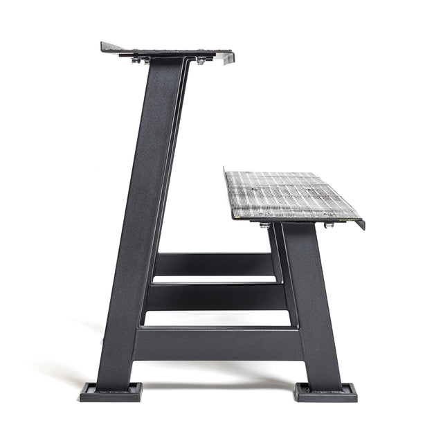 Side view of the Bells of Steel Kettlebell Rack in black metal with a mesh shelf, featuring sturdy legs and an industrial design—ideal for organizing your home gym or displaying competition kettlebells, shown on a white background.