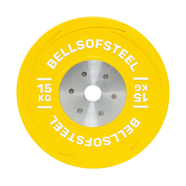 This 15 kg yellow KG Competition Bumper Plate by Bells of Steel features "BELLSOFSTEEL" and "15 KG" inscriptions. It has a silver center with bolt holes, making it ideal for Olympic lifting.