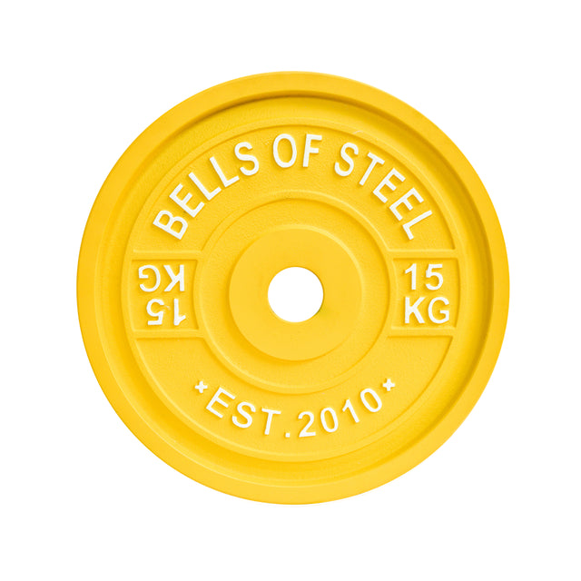 The vibrant yellow Calibrated Powerlifting Plate from Bells of Steel, weighing 15 kg, is imprinted with "BELLS OF STEEL" and "EST. 2010." This weightlifting plate is color-coded to meet IPF specifications and includes a central hole for seamless barbell loading.