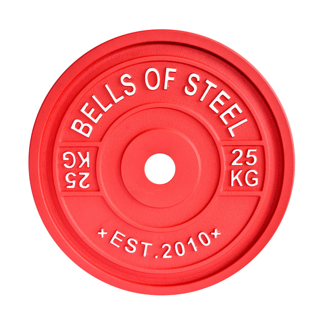 The Calibrated Powerlifting Plates - KG by Bells of Steel is a red 25 kg weight plate that features embossed text reading "BELLS OF STEEL" and "EST. 2010." Designed to IPF specifications for precision, this color-coded plate is circular with a center hole, making it ideal for barbell use.