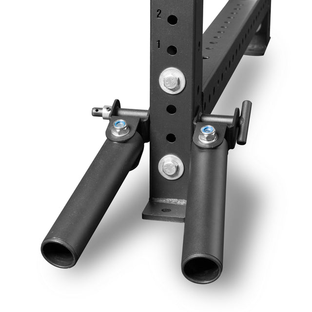 Close-up of the Bells of Steel Landmine Rack Attachment: a black extension with two angled pegs for weight plates, Olympic barbell protection, and attachment to a larger rack post with numbered holes for adjustable features.