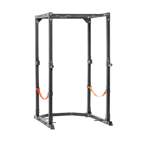 The Bells of Steel Light Commercial Power Rack (2.3" x 2.3", ⅝" holes) is a black steel, freestanding rack with adjustable holes and orange safety straps, ideal for weightlifting and strength training at home or in light commercial gyms.