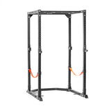 The Bells of Steel Light Commercial Power Rack (2.3" x 2.3", ⅝" holes) in black features orange safety straps for barbell protection, multiple adjustment holes for versatile placement, and is ideal for weightlifting and strength training.