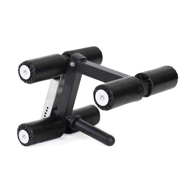 Introducing the Bells of Steel Bench Attachments: a compact black and metallic leg extension and curl machine attachment, featuring padded rollers, a support handle, and seamless model-matching adapters. This is ideal for home gym setups, allowing versatile exercises like the buzzsaw bench routine.