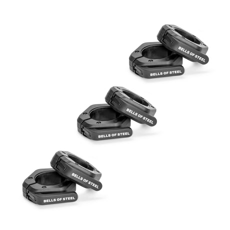 Six black Bells of Steel Magnetic Clamp Collars are arranged in three stacked pairs on a white background, each top collar slightly tilted with the logo clearly visible, highlighting these premium barbell collars.