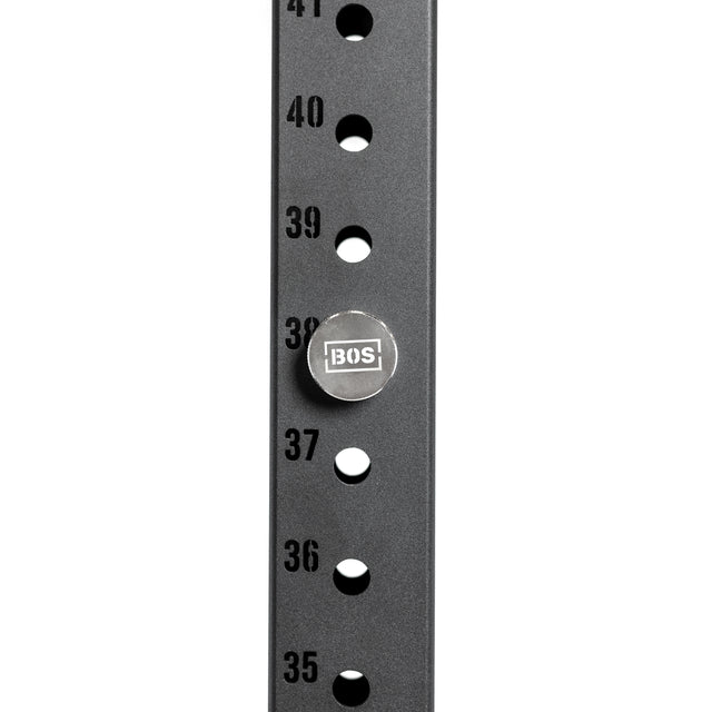 Close-up of a Bells of Steel anodized aluminum pole with numbered holes from 35 to 41, featuring a Magnetic Rack Attachment Pin labeled "BOS" in hole 38.