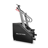 The Sisyphean Stepper by Bells of Steel, a sleek black and gray manual stair climber with red and gray handles and two steps, offers a stylish yet efficient way to tackle challenging workouts.