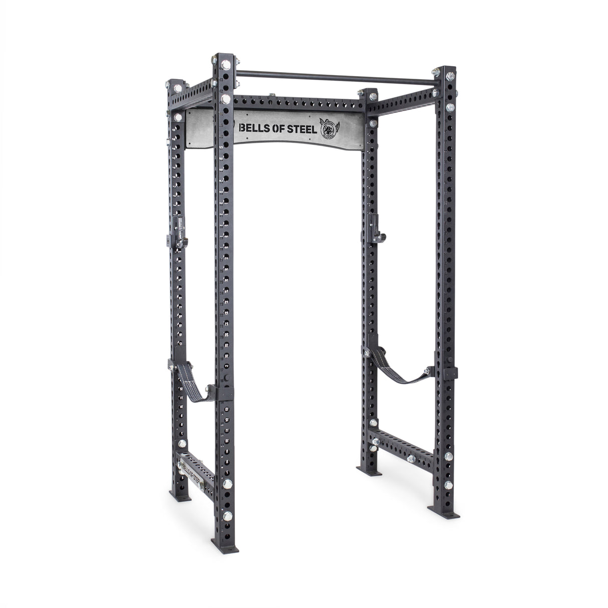 The Manticore Four Post Power Rack Builder by Bells of Steel, featuring 3" x 3" uprights with 1" holes for adjustable attachments and a pull-up bar, is perfect for home gyms. It includes safety straps and stands on a white background.