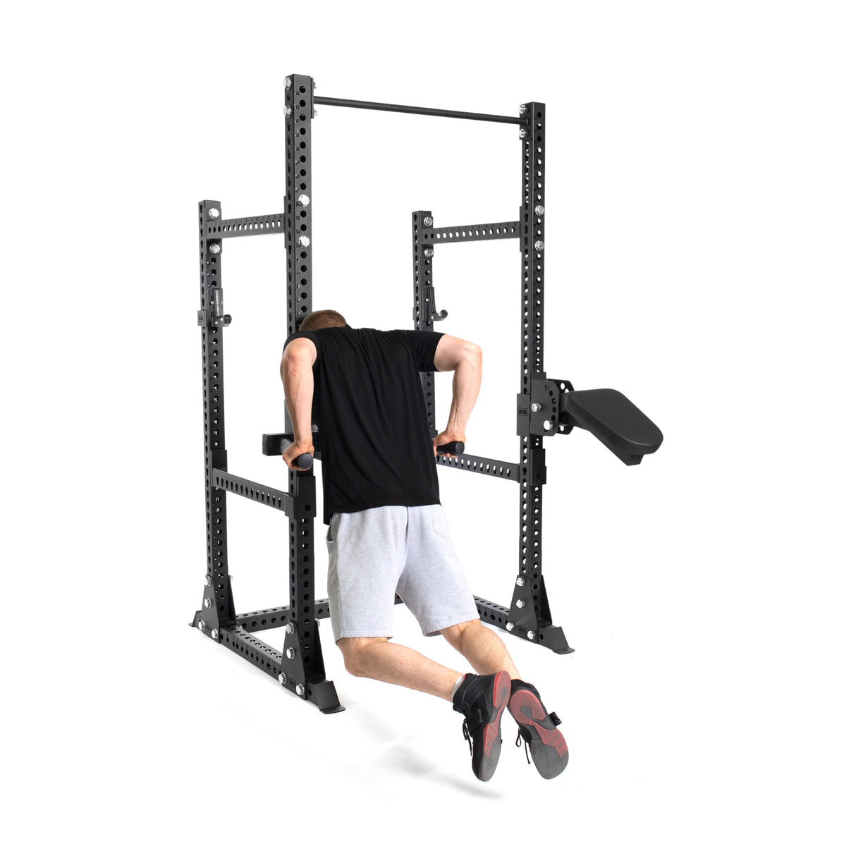 Picture of a Male model exercising on the Manticore Half Rack PREBUILT using a rack attachment