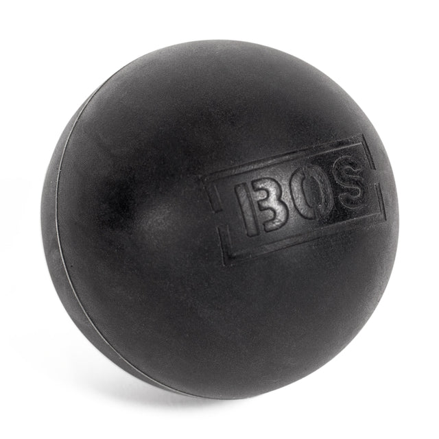 A black rubber massage ball from Bells of Steel, embossed with "BOS," is an excellent muscle massage and mobility tool. The textured surface and logo are clearly visible as the ball is set against a plain white background and slightly tilted.