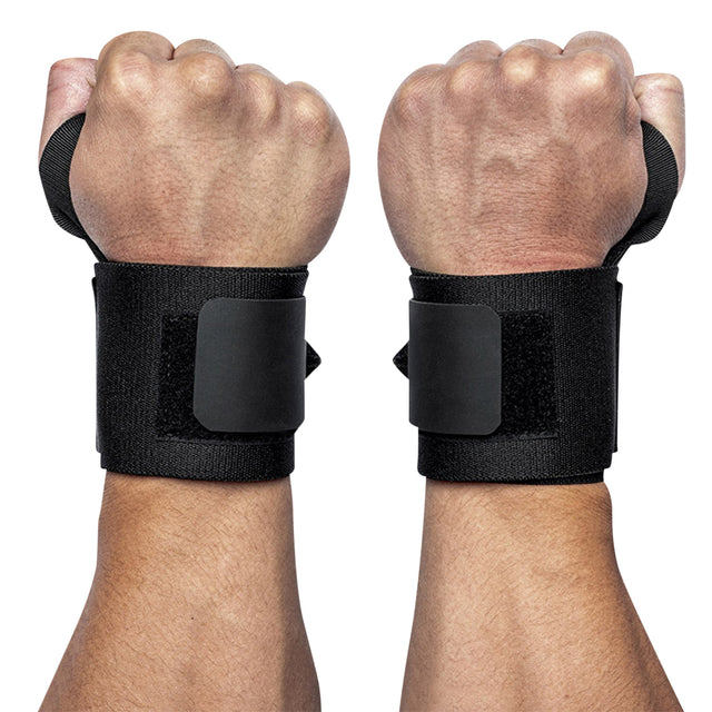 Two hands are depicted wearing Bells of Steel's Mighty Wrist Wraps, featuring black material and Velcro fasteners. These powerlifting essentials offer support, with fists clenched to convey a ready or supportive stance against a plain white background.