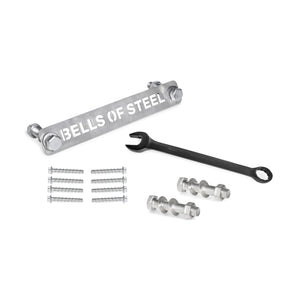 The Bells of Steel Manticore Hardware kit includes a labeled metal bar, black wrench, bolts, nuts, screws, and concrete anchor bolts—everything you need to assemble your Manticore Power Rack on a white surface.